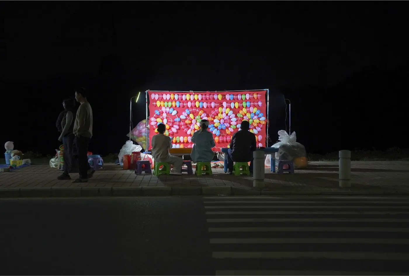 People Playing the Balloon Shooting Game, 2024 ©Yan Jiacheng